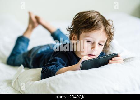4 year old boy playing with a smartphone. Stock Photo