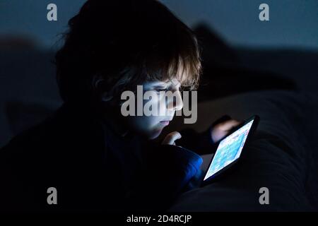 4 year old boy playing with a smartphone. Stock Photo