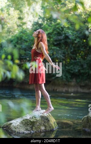 Woman walking on rocks. Stock Photo