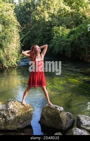 Woman walking on rocks. Stock Photo