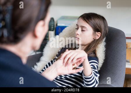 10 years old girl undergoing ericksonian hypnosis. Stock Photo