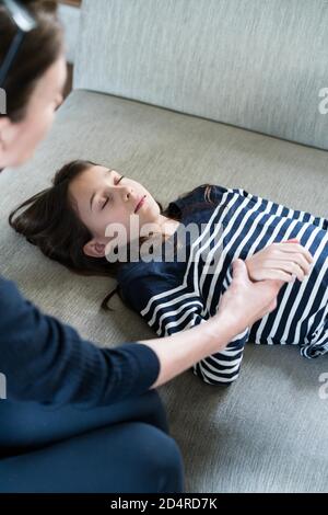 10 years old girl undergoing ericksonian hypnosis. Stock Photo