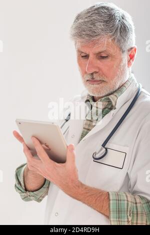Doctor using a digital tablet. Stock Photo