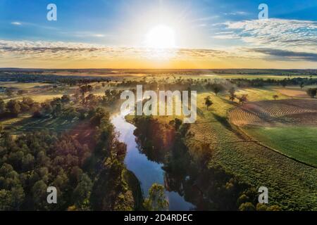 Macquarie river in Dubbo near Dundullmal homestead and farm fiels in aerial sunrise scenic view. Stock Photo