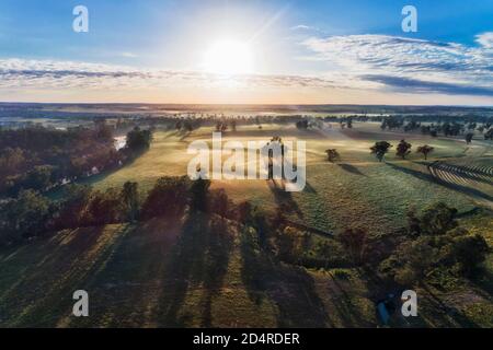 Agriculture cultivated plains on farms near Dubbo around Macquarie river  - sunrise aerial view against the sun. Stock Photo