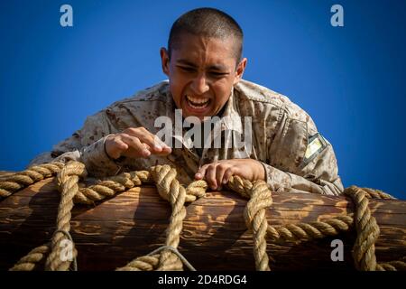 A recruit with Golf Company, 2nd Recruit Training Battalion, climbs a cargo net during the confidence course at Marine Corps Recruit Depot, San Diego, Nov. 4, 2019. The confidence course challenged recruits to face their fears and overcome them, pushing them forward in training in order to graduate. (U.S. Marine Corps photo by Lance Cpl. Zachary T. Beatty) Stock Photo