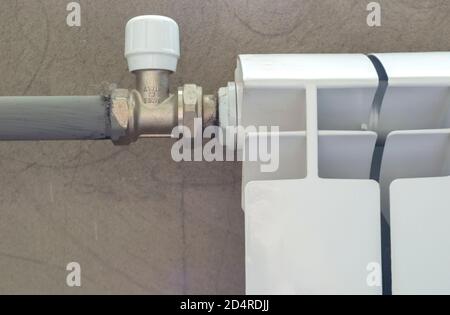 Thermostat of regulator on heating system in modern radiator Stock Photo