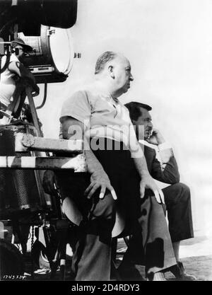 ALFRED HITCHCOCK and CARY GRANT on set location candid with Movie Crew during filming of NORTH BY NORTHWEST 1959 director ALFRED HITCHCOCK writer Ernest Lehman music Bernard Herrmann Metro Goldwyn Mayer Stock Photo