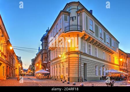 Street scene along Eugeniu de Savoya Street in the old town of Timisoara, Romania at twilight. Stock Photo