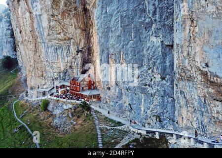 Aerial view of the Aescher Cliff (in Appenzell Canton, Switzerland) and the moutain restaurant catering to hikers. Stock Photo