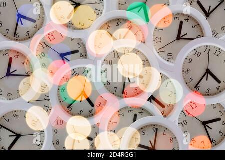 Composition with many clocks with lights, glitters and reflections Stock Photo