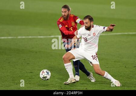 Madrid, Spain. 10th Oct, 2020. Spain's Sergio Ramos (L) vies with Switzerland's Admir Mehmedi during the UEFA Nations League football group match between Spain and Switzerland in Madrid, Spain, Oct. 10, 2020. Credit: Edward F. Peters/Xinhua/Alamy Live News Stock Photo