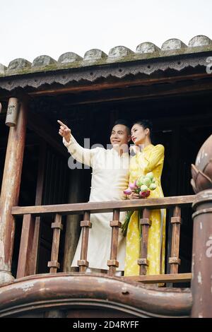 Vietnamese couple standing on balcony Stock Photo