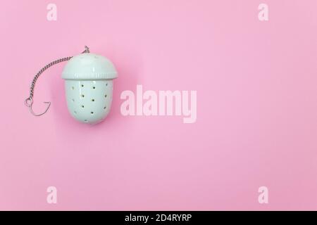 Top view of a white tea strainer isolated on a pink background Stock Photo