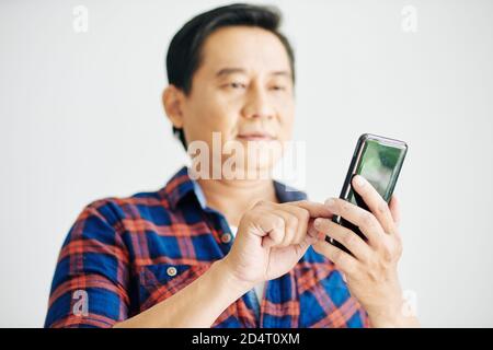 Mature man texting Stock Photo