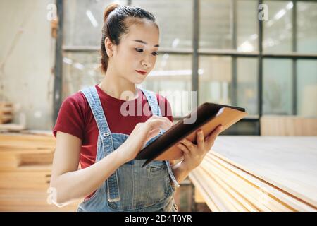 Carpentry shop manager checking e-mails Stock Photo