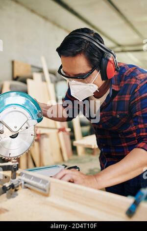 Cutting wooden plank Stock Photo