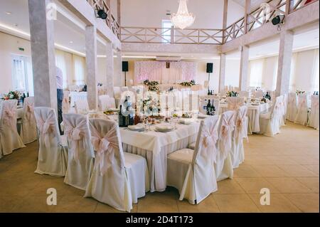 Banquet tables are served for guests in the elegantly decorated halls of the restaurant. Stock Photo