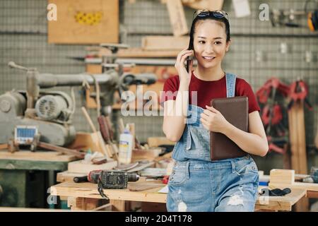 Female carpenter calling on phone Stock Photo