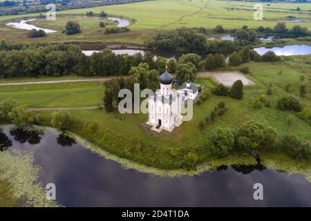 Top view of the ancient Church of the Intercession on the Nerl in August morning (aerial photography). Bogolyubovo, Russia Stock Photo