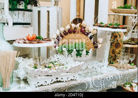 Beautifully decorated catering banquet table with different food snacks and appetizers. Stock Photo