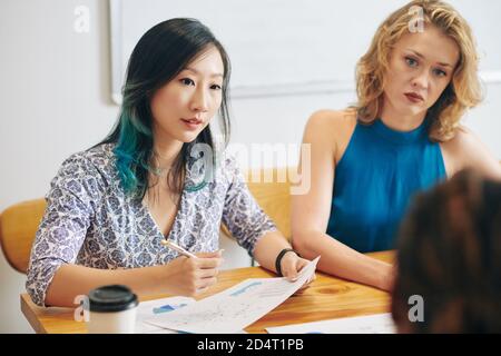 Businesswoman talking to colleagues Stock Photo