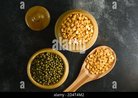 Various sources of vegetable protein beans, lentils, peas, chickpeas, mung bean in bowls. Indian Pulses uncooked , Lentils, Rice healthy balanced diet Stock Photo