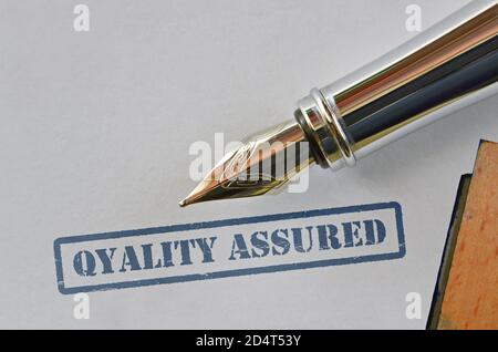 Concept about product quality control with rubber stamp and fountain pen Stock Photo