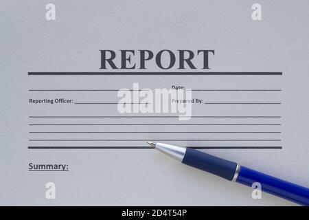 Blank report form printed on paper and a pen Stock Photo