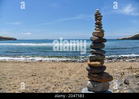 Pebbles balanced on the beach Stock Photo