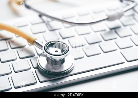 Online doctor concept with stethoscope on keyboard. Stock Photo