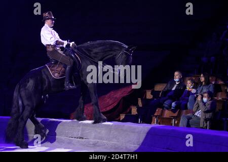 Kyiv, Ukraine. 10th Oct, 2020. The horse and its tamer perform during the presentation of the new show 'Birthday. Circus Festival' at the National Circus in Kyiv, Ukraine October 10, 2020. Credit: Anatolii Stepanov/ZUMA Wire/Alamy Live News Stock Photo