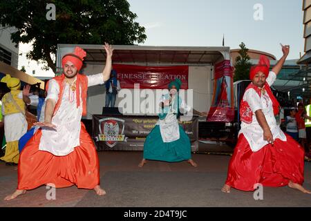 Indian men in traditional clothing dancing at Diwali festival. Tauranga, New Zealand, November 7 2015 Stock Photo