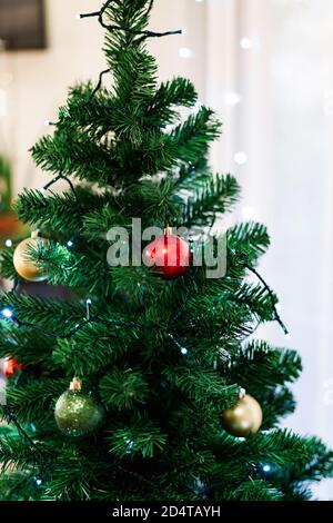 Multi-colored Christmas balls on a fluffy green Christmas tree. Stock Photo