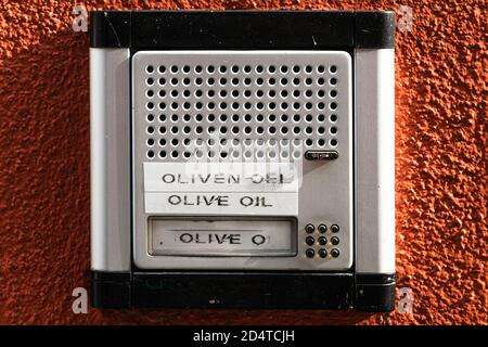 Door bell with sign for olive oil sale Stock Photo