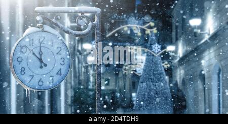 Vintage street clock in winter. New year time  Stock Photo