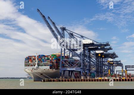 Giant container ship (the OOCL INDONESIA) in Felixstowe Docks viewed from Landguard Point, Suffolk, UK. Stock Photo