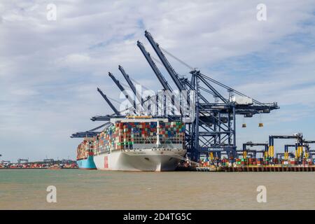 Giant container ship (the OOCL INDONESIA) in Felixstowe Docks viewed from Landguard Point, Suffolk, UK. Stock Photo