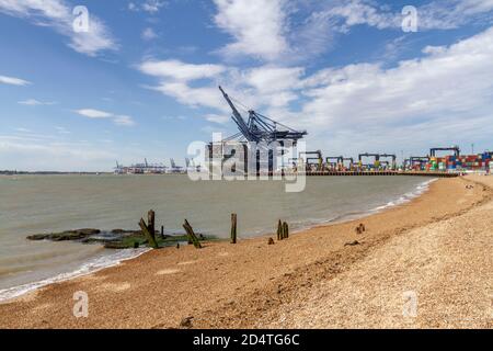 Giant container ship (the OOCL INDONESIA) in Felixstowe Docks viewed from Landguard Point, Suffolk, UK. Stock Photo