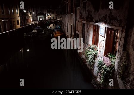 illuminated window at night on canal front in venice Stock Photo