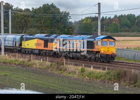 Electro-Motive Diesel Type JT42CWR Class 66 diesel locomotive at the front of double header freight trainn with Colas Rail Freight Class 60, 60047 at Stock Photo