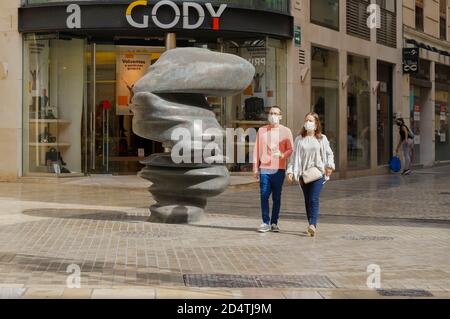 Couple wearingg mask having a stroll at Malaga centre, Andalucia, Spain. Stock Photo