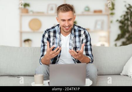 Happy man using laptop for video call and talking Stock Photo