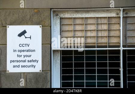 Sign on the wall of a car park building explaining CCTV is in operation. No people. Stock Photo