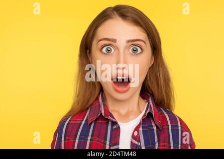 Wow, unbelievable! closeup caricature comic portrait of shocked or surprised funny young woman looking at camera with open mouth and amazed big eyes. Stock Photo