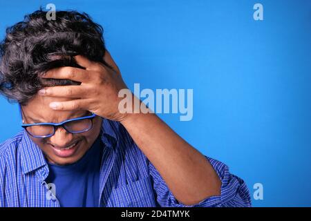 Close up of sad man covering face with hand. Stock Photo