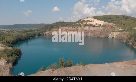 Panorama of emerald lake in a flooded quarry. Stock Photo