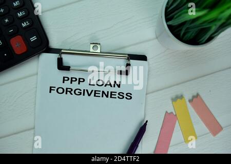 PPP Loan Forgiveness write on a paperwork isolated on office desk. Stock Photo