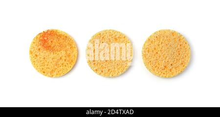 Yellow face wash sponges isolated on a white background, top view. Stock Photo