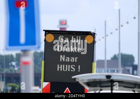 Dutch Corona virus COVID 19 sign board warning people to stay away from crowded places Stock Photo